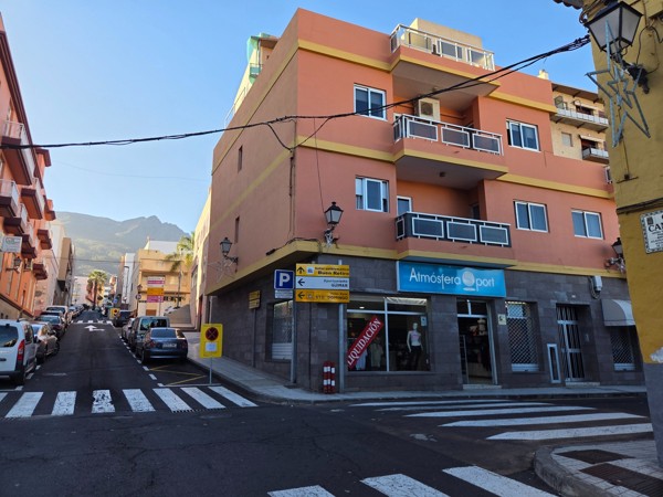 Carrefour de Güímar avec immeubles colorés et circulation en pente vers la montagne.